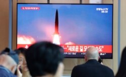 People watch a TV showing a file image of a North Korea's missile launch during a news program at the Seoul Railway Station in Seoul, South Korea, Tuesday, Aug. 6, 2019.