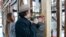 In this March 28, 2018 photo, artist Ryan Mendoza and his wife, Fabia Mendoza, put up siding, in Providence, R.I., on a house where Rosa Parks sought refuge after fleeing the South. 