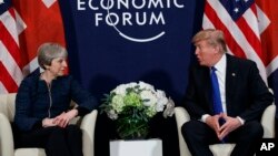 FILE - A Thursday, Jan. 25, 2018 file photo of US President Donald Trump meeting with British Prime Minister Theresa May at the World Economic Forum in Davos, Switzerland. President Donald Trump has wished Prince Harry and fiancee Meghan Markle well and says he is not aware of having received an invitation to their royal wedding in May. 