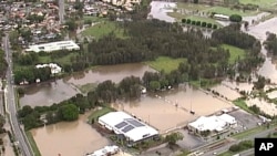 FILE - This image from video shows flooded fields on Gold Coast, Australia, Jan. 18, 2020. More heavy rain lashed parts of Australia’s New South Wales and Queensland states on Jan. 26, causing flash floods, while wildfires kept burning elsewhere.