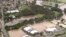 FILE - This image from video shows flooded fields on Gold Coast, Australia, Jan. 18, 2020. More heavy rain lashed parts of Australia’s New South Wales and Queensland states on Jan. 26, causing flash floods, while wildfires kept burning elsewhere.