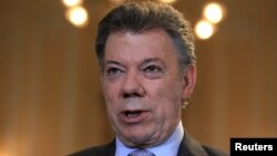 FILE - Colombia's President Juan Manuel Santos speaks during a Reuters interview at the presidential palace in Bogota, April 7, 2015. 