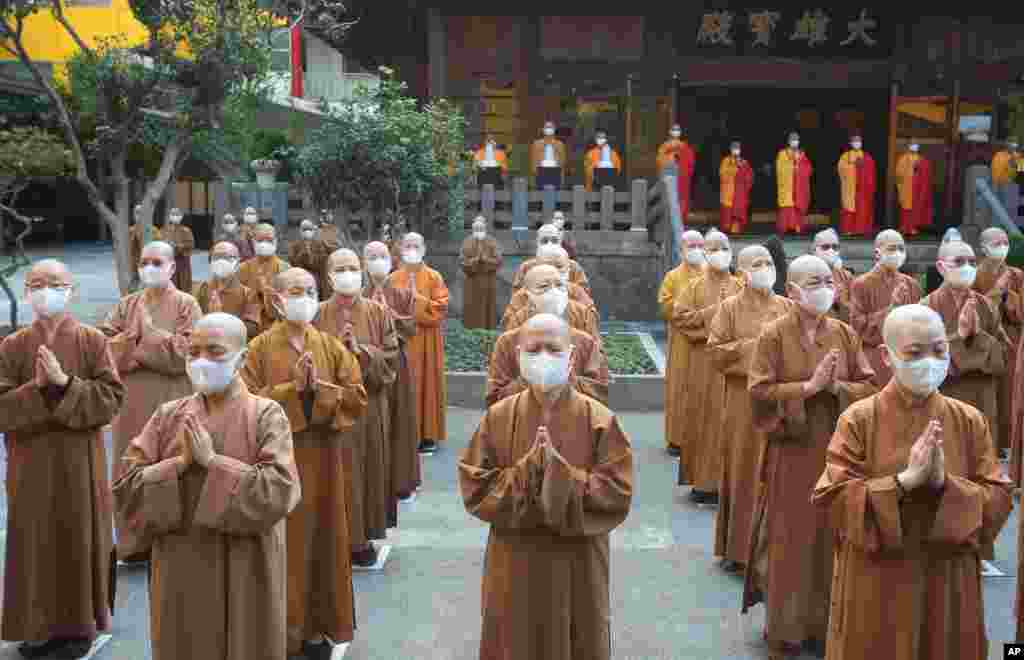 Monks and nuns pray together during Buddha's Birthday celebrations at the Lin Chi Temple in Taipei, Taiwan.