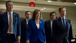 House Speaker Nancy Pelosi, D-Calif., accompanied by members of Congress, arrives for a briefing on last week's targeted killing of Iran's senior military commander Gen. Qassem Soleimani, on Capitol Hill in Washington, Jan. 8, 2020.