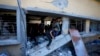 Palestinians search for the bodies of their relatives killed in an Israeli bombardment of a school in Deir al-Balah, central Gaza Strip, Oct. 10, 2024.