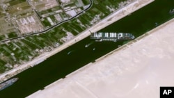 This satellite image from Cnes2021, Distribution Airbus DS, shows the cargo ship MV Ever Given stuck in the Suez Canal near Suez, Egypt, Thursday, March 25, 2021. 