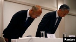 McDonald's Holdings Company Ltd. Senior Vice President Takehiko Aoki, right, and McDonald's Company Ltd. Senior Vice President Hidehito Hishinuma bow at the end of a news conference in Tokyo, Jan. 7, 2015. 