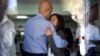 Former Haitian President Michel Martelly, left, comforts Patricia Preval, the daughter of Haiti's late former President Rene Preval, at the Sainte Claire hospital in Petion-Ville, Haiti, March 3, 2017. 