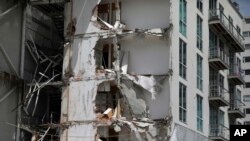 This Sept. 24, 2017, photo shows an apartment building that was partially destroyed during the 7.1 magnitude earthquake, on Emiliano Zapata Avenue in Mexico City. The eco-friendly apartment building with its wood-paneled balconies and a solar-paneled roof collapsed when a corner column failed, and the flat-slab structure pancaked, said Eduardo Miranda, a professor of civil and environmental engineering. 