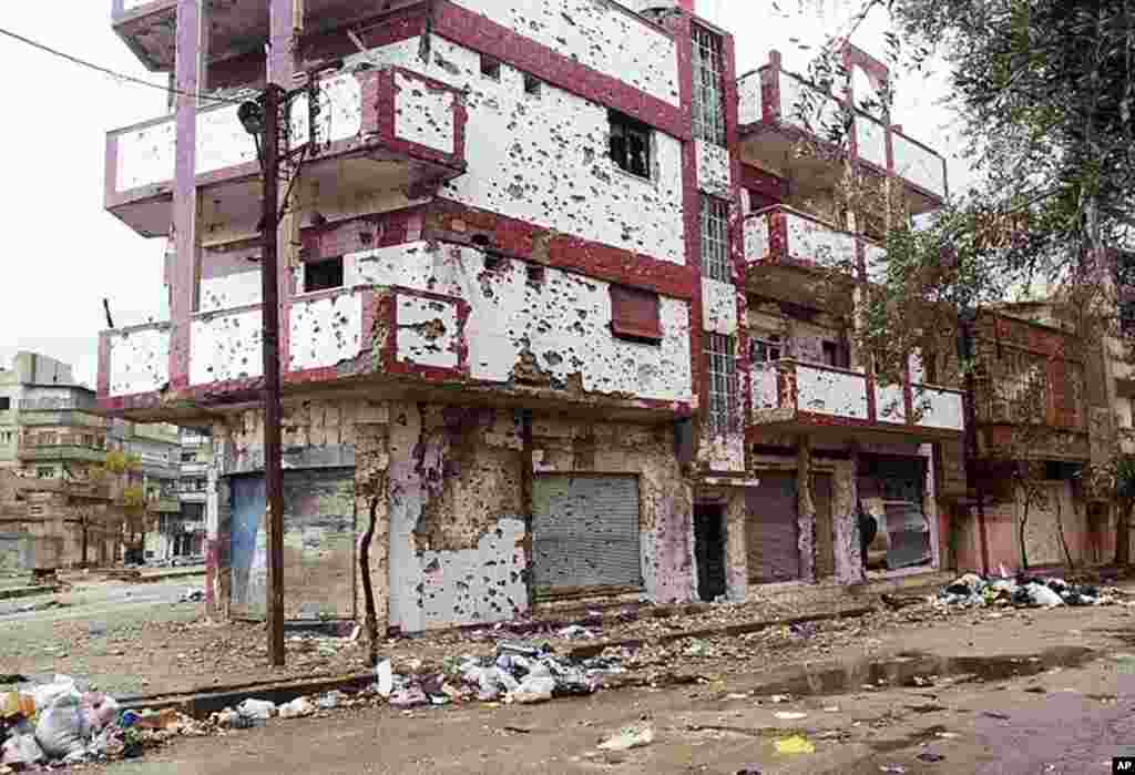 Houses are being pounded by Syrian government forces shelling in Homs. Activists say hundreds have died in the onslaught. (AP/Local Coordination Committees in Syria)
