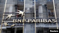 FILE - The logo of BNP Paribas is seen on the bank's building in Paris, May 30, 2014. 