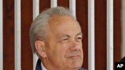  FILE - Horse trainer Jerry Hollendorfer stands in the paddock at Turfway Park in Florence, Ky., March 22, 2014. Hollendorfer was banned by the ownership of Santa Anita, June 22, 2019, after a fourth horse from his stable died.