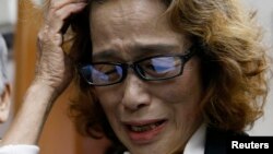 FILE - Junko Ishido, mother of Japanese journalist Kenji Goto who was slain by Islamic State militants, speaks to reporters at her house in Tokyo, Feb. 1, 2015. 