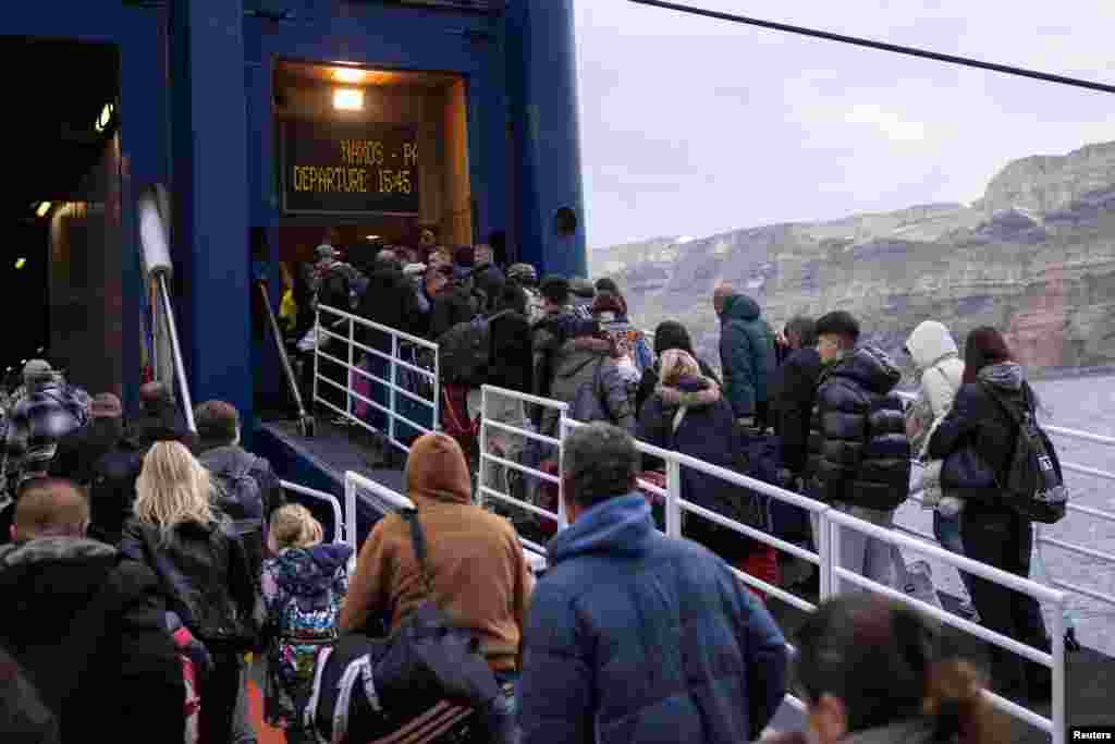 People board a ferry to Piraeus during an increased seismic activity on the island of Santorini, Greece.