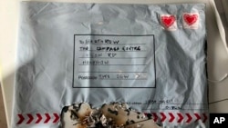 This photo dated March 5, 2019, and issued by Britain's Metropolitan Police shows a suspect package after it ignited. It was one of three packages being treated as a linked series by Britain’s counterterrorism police. A fourth was found March 6 at the University of Glasgow.