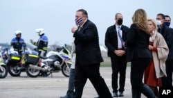 U.S. Secretary of State Mike Pompeo, left, walks to a motorcade vehicle after stepping off a plane at Paris Le Bourget Airport, Saturday, Nov. 14, 2020, in Le Bourget, France. Pompeo is beginning a 10-day trip to Europe and the Middle East. (AP…