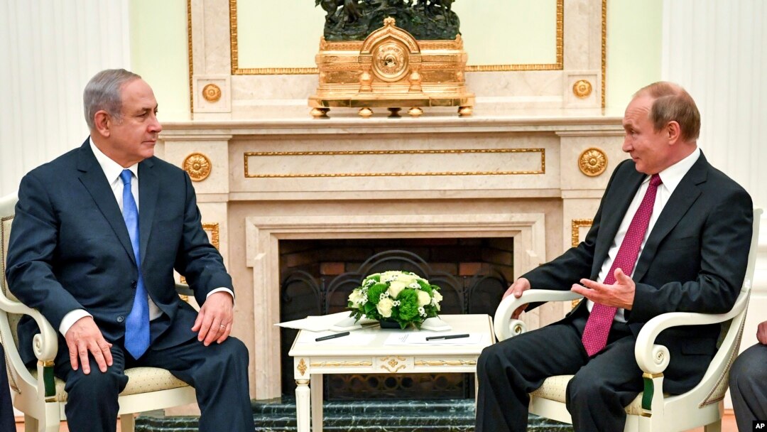 Russian President Vladimir Putin, right, speaks with Israeli Prime Minister Benjamin Netanyahu during their meeting at the Kremlin in Moscow, July 11, 2018.