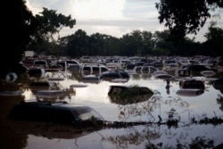 Vehicles are submerged at a plot flooded by the Chamelecon River due to heavy rain caused by Storm Iota, in La Lima, Honduras, Nov. 19, 2020.