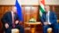 Russian President Vladimir Putin, left, and leader of Georgia's breakaway province of Abkhazia, Raul Khadzhimba, talk during their meeting in the provincial town of Pitsunda, Aug. 8, 2017. 