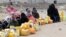 A five-day humanitarian truce in Yemen appeared to be broadly holding Wednesday, as people wait to collect water from a public tap amidst an acute water shortage, in Sana'a, May 13, 2015. 
