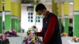 A member of the Indonesia Red Cross prepares coffins for the victims of AirAsia Flight 8501 at the main hospital in Pangkalan Bun.&nbsp; More ships arrived Friday with sensitive equipment to hunt for the fuselage of the flight and the more than 145 people still missing since it crashed into the sea five days ago.