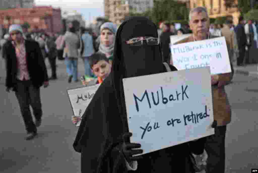 A woman carrying a placard referring to Egyptian President Hosni Mubarak attends a demonstration by anti-government protesters in Cairo's Tahrir Square, Egypt, Monday, Jan. 31, 2011. A coalition of opposition groups called for a million people to take to 