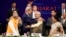 U.S. Secretary of State John Kerry (front, 2nd L) and India's Prime Minister Narendra Modi (front, 2nd R) gesture after shaking hands at the Vibrant Gujarat Summit in Gandhinagar in the western Indian state of Gujarat, Jan. 11, 2015. 
