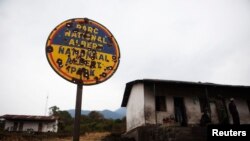 FILE - A bullet-riddled sign shown on Aug. 30, 2010, marks the entrance to Virunga National Park in eastern Congo.