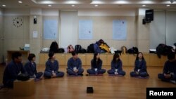 Participants prepare to be locked up at Prison Inside Me, a mock prison facility, in Hongcheon, South Korea, November 10, 2018. 