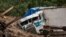 FILE - A truck is covered by mud at the side of a mudslide caused by the passage of Hurricane Eta in Queja, San Cristobal Verapaz, Guatemala, Nov. 7, 2020. Officials on Nov. 14 expressed concern about the approach of Tropical Storm Iota.