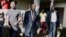 FILE - Maurice Kamto, a presidential candidate of Renaissance Movement (MRC), walks with his staff after his news conference at his headquarter in Yaounde, Cameroon, Oct. 8, 2018. 