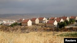 FILE - Houses are seen in the West Bank Jewish settlement of Karmel, near Hebron, May 24, 2016. 
