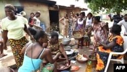 Des femmes de la communauté baoulé préparent de la nourriture lors des célébrations dans le village d'Assounvoue, à 40 kilomètres de Yamoussoukro, au centre de la Côte d'Ivoire, le 1er avril 2018.