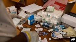 An employee at Sierra Leone Youth Development and Child Link (SLYDCL) provides medical care for Kush users at Moa Wharf, a drug den in Freetown, Sierra Leone, Friday, April 26, 2024. (AP Photo/ Misper Apawu)