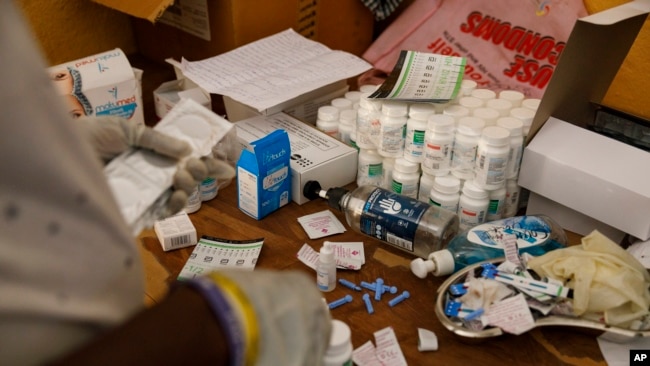 An employee at Sierra Leone Youth Development and Child Link (SLYDCL) provides medical care for Kush users at Moa Wharf, a drug den in Freetown, Sierra Leone, Friday, April 26, 2024. (AP Photo/ Misper Apawu)