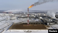 FILE PHOTO: A flame burns from a tower at Vankorskoye oil field owned by Rosneft company north of the Russian Siberian city of Krasnoyarsk