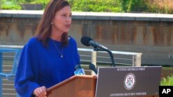 FILE - Michigan Governor Gretchen Whitmer speaks at an event at Rotary Park along the Grand River in Lansing, Michigan, Aug. 23, 2021.