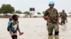 A girl walks in water after heavy rains and floods forced hundreds of thousands of people to leave their homes, in the town of Pibor, Boma state, South Sudan, Nov. 6, 2019.