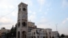 A man rides a bicycle past the landmark clock tower of the central Syrian city of Hama on Jan. 27, 2025. 