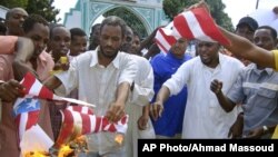 A group of Kenyan Muslims burn the U.S. flag following afternoon prayers outside the Sakina Jamia Mosque in the port city of Mombasa, Sept. 14, 2012.
