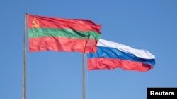 FILE - Flags of Transdniestria and Russia fly in a square in Tiraspol, Moldova's breakaway region of Transdniestria, Jan. 4, 2025.