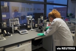 FILE - A Johnson & Johnson scientist works in a laboratory during the development and testing of the Janssen coronavirus disease vaccine. (Johnson & Johnson/Handout via Reuters)