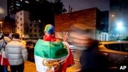 FILE - Iranians in Frankfurt gather in front of the Iranian Consulate that was shut down in response to the execution of Iranian German prisoner Jamshid Sharmahd, who was kidnapped in Dubai in 2020 by Iranian security forces, in Frankfurt, Germany, Oct. 31, 2024. 