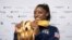 Simone Biles of the United States shows her five gold medals she won at the Gymnastics World Championships in Stuttgart, Germany, Oct. 13, 2019.