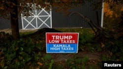 A sign supporting former U.S. president Donald Trump stands posted in the election battleground Erie County township of North East, Pennsylvania, Oct. 23, 2024.