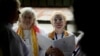 Bridget Mary Meehan, right, an American co-founder of the Association of Roman Catholic Women Priests, takes part in a secret ordination of six women on a barge on the Tiber River in Rome on Oct. 17, 2024. The ceremony was not authorized by the Vatican.