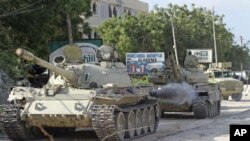 African Union Mission in Somalia [AMISOM] tanks patrol after fighting against Islamist insurgents al-Shabab, in Suqa Holaha village of Horiwaa district, Mogadishu, Somalia, March 3, 2012.