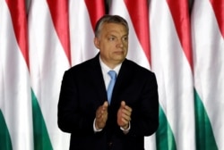 FILE - Hungarian Prime Minister Viktor Orban applauds as he presents the program of his Fidesz party for European Parliament elections in Budapest, Hungary, April 5, 2019.