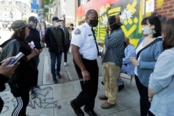 Seattle Fire Chief Harold Scoggins, center, arrives to meet with residents and community leaders, June 14, 2020, inside what has been named the Capitol Hill Occupied Protest zone in Seattle.