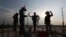 Workers are silhouetted at the construction site of a bridge in Krasang Chrum village on the outskirts of Phnom Penh, Cambodia, Thursday, May 14, 2020. (AP Photo/Heng Sinith)